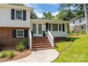 Charming two-story home with brick and white siding, black shutters, and inviting front yard at 1013 Eaglewood Ave, Charlotte, NC 28212