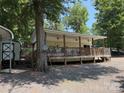 Home featuring a large covered porch with ceiling fans at 104 Deer Park Rd # D143, Mount Gilead, NC 27306