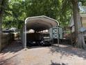Covered parking area with multiple golf carts at 104 Deer Park Rd # D143, Mount Gilead, NC 27306