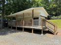 Inviting exterior deck with ceiling fans and wooden railings at 104 Deer Park Rd # D143, Mount Gilead, NC 27306