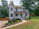 Two-story home with a charming porch and landscaped front yard, blending comfort with curb appeal at 1256 Canseco Ln, Hickory, NC 28602