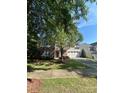 Charming two-story home with a well-manicured lawn, mature trees, and a two-car garage at 1304 Ridge Haven Rd, Waxhaw, NC 28173