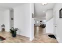 Bright foyer with hardwood floors, white walls, and view into the rest of the home at 13140 Sudwick Ln, Charlotte, NC 28278