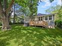 Lush backyard with green grass and a wooden deck, perfect for outdoor entertaining at 144 Walnut St, Chester, SC 29706