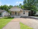 Charming home with a well-manicured lawn and inviting front porch at 144 Walnut St, Chester, SC 29706