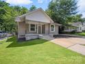 Charming home with a well-manicured lawn and inviting front porch at 144 Walnut St, Chester, SC 29706
