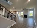 Spacious living room featuring luxury vinyl plank flooring, a modern fireplace, and abundant natural light at 1459 Mocksville Hwy # 19, Statesville, NC 28625