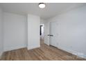 Cozy bedroom featuring hardwood floors and a closet with white doors at 1524 Enochville Rd, Kannapolis, NC 28081