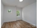 Bright bedroom featuring hardwood floors, fresh paint, and a window view at 1524 Enochville Rd, Kannapolis, NC 28081