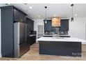 Modern kitchen features gray cabinets, stainless appliances, island, and stunning countertops at 1528 Enochville Rd, Kannapolis, NC 28081