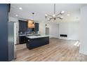 Open floor plan showcasing the kitchen, island, fireplace and natural light at 1528 Enochville Rd, Kannapolis, NC 28081