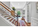 Inviting foyer with hardwood floors, staircase, and ample natural light at 1600 Buckland Ct, Indian Land, SC 29707