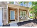 Charming front porch with stone accents, a light blue door, and cozy seating, perfect for relaxing at 1817 Tradd Ave, Clover, SC 29710