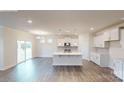 Bright, open-concept kitchen with white cabinets, stainless steel appliances, and a center island at 2070 Skyhawk Dr, York, SC 29745