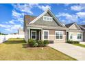 Charming exterior view of a two-story home with a well-manicured lawn and a paved driveway on a sunny day at 218 Canina Ln, Indian Trail, NC 28079