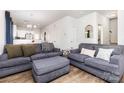 Cozy living room with plush seating, modern decor, and a seamless transition to the dining area and kitchen at 218 Canina Ln, Indian Trail, NC 28079