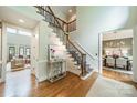 Elegant foyer features hardwood floors, a staircase with iron railings, and views of the dining and living spaces at 2300 Richardson Dr, Charlotte, NC 28211