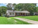 Ranch-style home featuring a spacious front yard and mature trees at 2536 Cambridge Dr, Lancaster, SC 29720