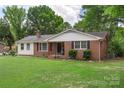 Well-maintained ranch-style home featuring a spacious front yard and mature trees at 2536 Cambridge Dr, Lancaster, SC 29720