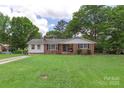 Well-maintained ranch-style home featuring a spacious front yard and mature trees at 2536 Cambridge Dr, Lancaster, SC 29720