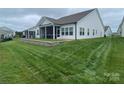 A well-maintained backyard with a screened porch and a retaining wall at 25952 Appleyard Ct, Lancaster, SC 29720