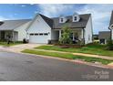 Traditional single-Gathering home with attached garage, dormer windows, and neatly landscaped yard at 25952 Appleyard Ct, Lancaster, SC 29720