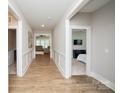 Inviting hallway featuring stylish wood floors, decorative molding, and neutral paint at 25952 Appleyard Ct, Lancaster, SC 29720