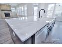 Bright kitchen features a large island with white marble countertop and modern black fixtures at 277 Triple Ponds Ct, Clover, SC 29710