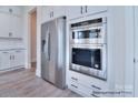 Kitchen features stainless steel appliances and sleek white cabinetry at 277 Triple Ponds Ct, Clover, SC 29710