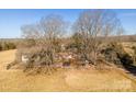 Wide aerial view of the property with mature trees, play area, and surrounding land at 2808 Water Plant Rd, Maiden, NC 28650