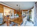 Elegant dining room features a spacious wooden table, stylish chandelier, and natural light from the large windows at 2808 Water Plant Rd, Maiden, NC 28650