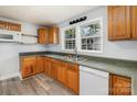 Functional kitchen featuring classic wood cabinets, laminate countertops, and a stainless steel sink with a view at 403 Weaver St, Cherryville, NC 28021