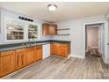 Functional kitchen featuring classic wood cabinets, laminate countertops, and durable wood-look flooring at 403 Weaver St, Cherryville, NC 28021