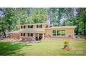 Charming two-story home with brick accents, a landscaped yard, and a welcoming front porch at 411 Saint Andrews Rd, Statesville, NC 28625