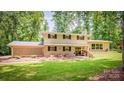 Charming two-story home with brick accents, a landscaped yard, and a welcoming front porch at 411 Saint Andrews Rd, Statesville, NC 28625