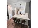 Modern kitchen with stainless steel appliances, white cabinets, and marble countertops at 411 Saint Andrews Rd, Statesville, NC 28625