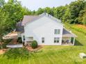 Aerial view of a two story home with a well-manicured lawn, lush landscaping, and bright white siding at 5963 Pale Moss Ln, Charlotte, NC 28269
