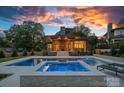 Backyard retreat featuring a luxurious pool, spa, and stylish outdoor seating area at 639 Edgemont Rd, Charlotte, NC 28211