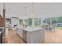 Bright, open kitchen with marble island, stainless steel appliances, and seamless flow to dining and living areas at 639 Edgemont Rd, Charlotte, NC 28211
