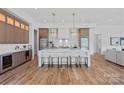 Elegant kitchen featuring a large island with seating, modern lighting, and stylish cabinetry at 639 Edgemont Rd, Charlotte, NC 28211