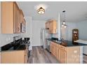 Well-lit kitchen featuring stainless steel appliances, black granite countertops, and wood cabinets at 6834 Creft Cir, Indian Trail, NC 28079