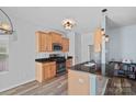 Modern kitchen with stainless steel appliances, dark countertops, and wooden cabinetry at 6834 Creft Cir, Indian Trail, NC 28079