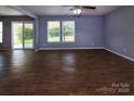 Bright living room with wood-look floors, backyard access, and neutral paint at 7623 Monarch Birch Ln, Charlotte, NC 28215