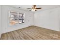 Bright and airy living room with hardwood floors, ceiling fan, and a view of the front yard at 81 Kirk St, Salisbury, NC 28144