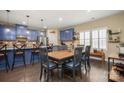 Dining area featuring a table with seating for six, wooden floors and views of the gourmet kitchen at 8232 Bretton Woods Dr, Charlotte, NC 28227