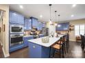 Modern kitchen with stainless steel appliances, blue cabinets, white countertops and a large center island at 8232 Bretton Woods Dr, Charlotte, NC 28227
