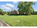 Beautiful brick home with a well-kept lawn and mature landscaping, showcasing the property's charm and curb appeal at 104 Fairwind Ct, Fort Mill, SC 29708