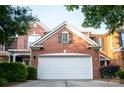 Close-up of a brick home featuring a garage door, gable, and manicured landscaping at 10433 Blairbeth St, Charlotte, NC 28277