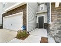 Welcoming entrance of a modern home with a dark front door and a two-car garage, presenting a stylish exterior at 1133 Streamside Ln, York, SC 29745