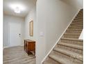 Inviting foyer with hardwood floors, staircase, and a stylish wooden console table, creating a warm ambiance at 1133 Streamside Ln, York, SC 29745